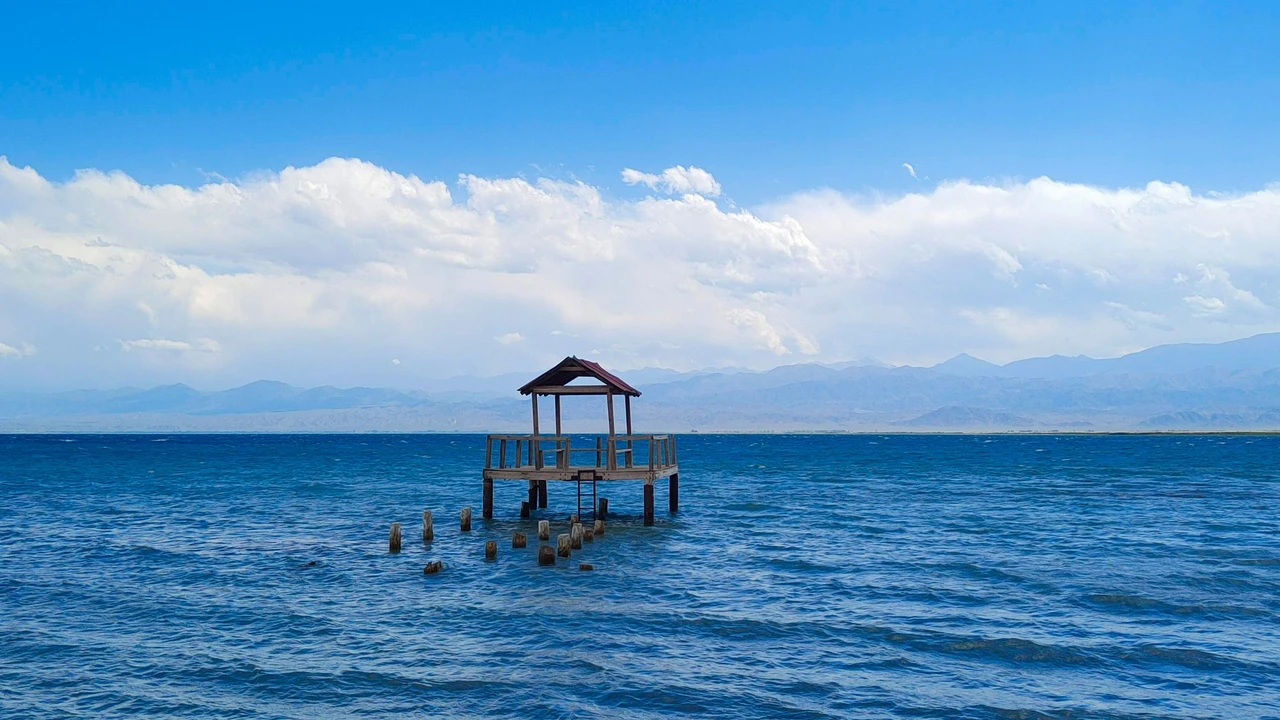Serene lakeside view of Issyk-Kul lake in Kyrgyzstan surrounded by mountains